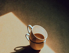 Two cups of TAU coffee in morning light